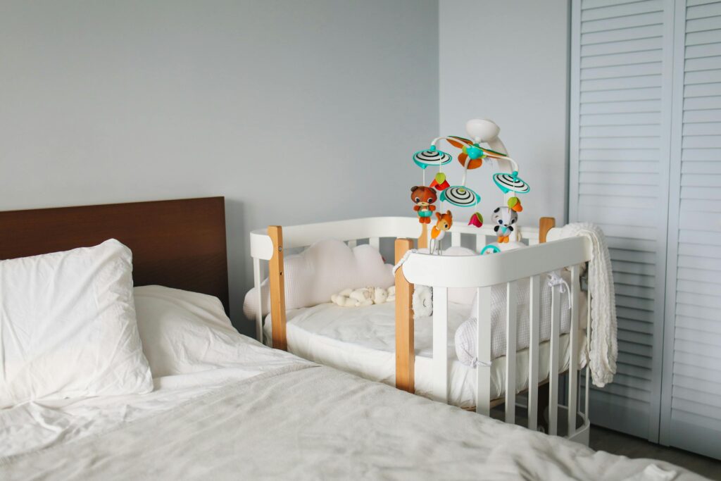 A serene bedroom with a crib and bed, ideal for baby comfort and modern decor.